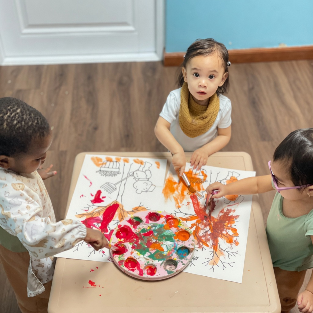 Children painting and doing art activities at Bambini child care Guam